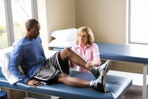 A physical therapy session showing rehabilitation exercises, demonstrating the crucial connection between physical recovery and mental resilience during the limb lengthening process.